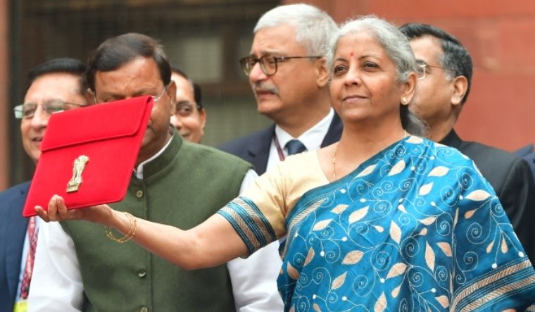 Nirmala Sitharaman with officials before heading to the Parliament to present the Interim Union Budget 2024